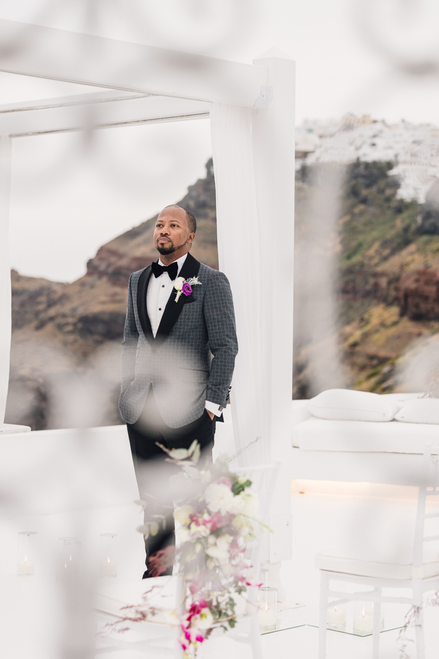 Groom looking out over the caldera from Dana Villas