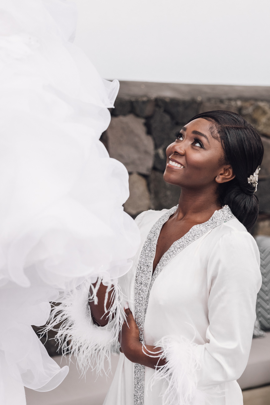 Bride admiring her wedding dress