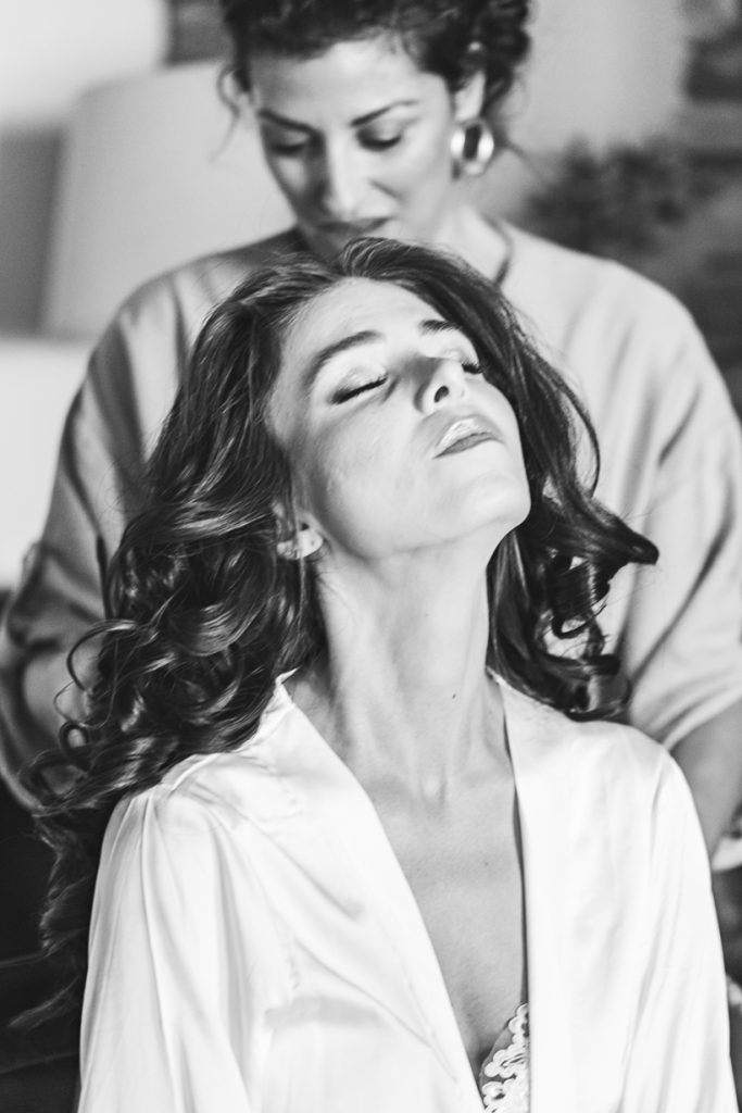 Bride having her hair done during the wedding preparations in Haraki village, Rhodes.