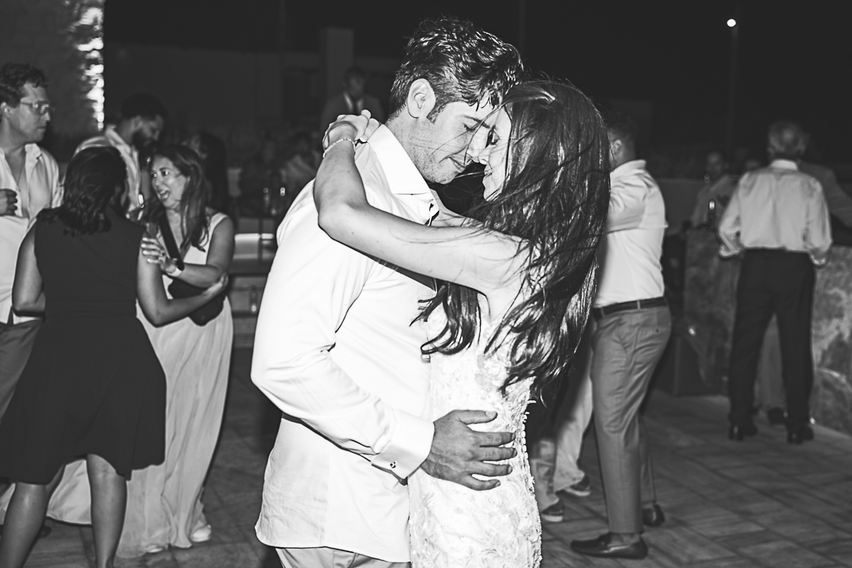 Newlyweds dancing together during their Greek wedding reception in Lindos.
