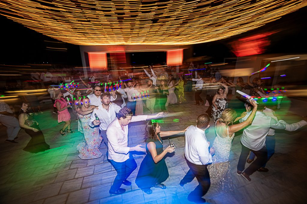 Wedding guests dancing and celebrating during a lively Greek wedding party in Lindos, Rhodes.